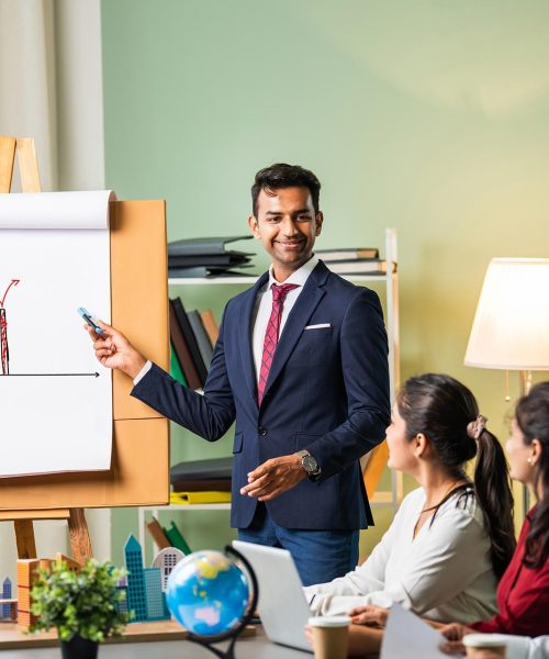 imgi_7_group-of-businesspeople-looking-at-young-indian-as-2025-01-16-13-05-04-utc